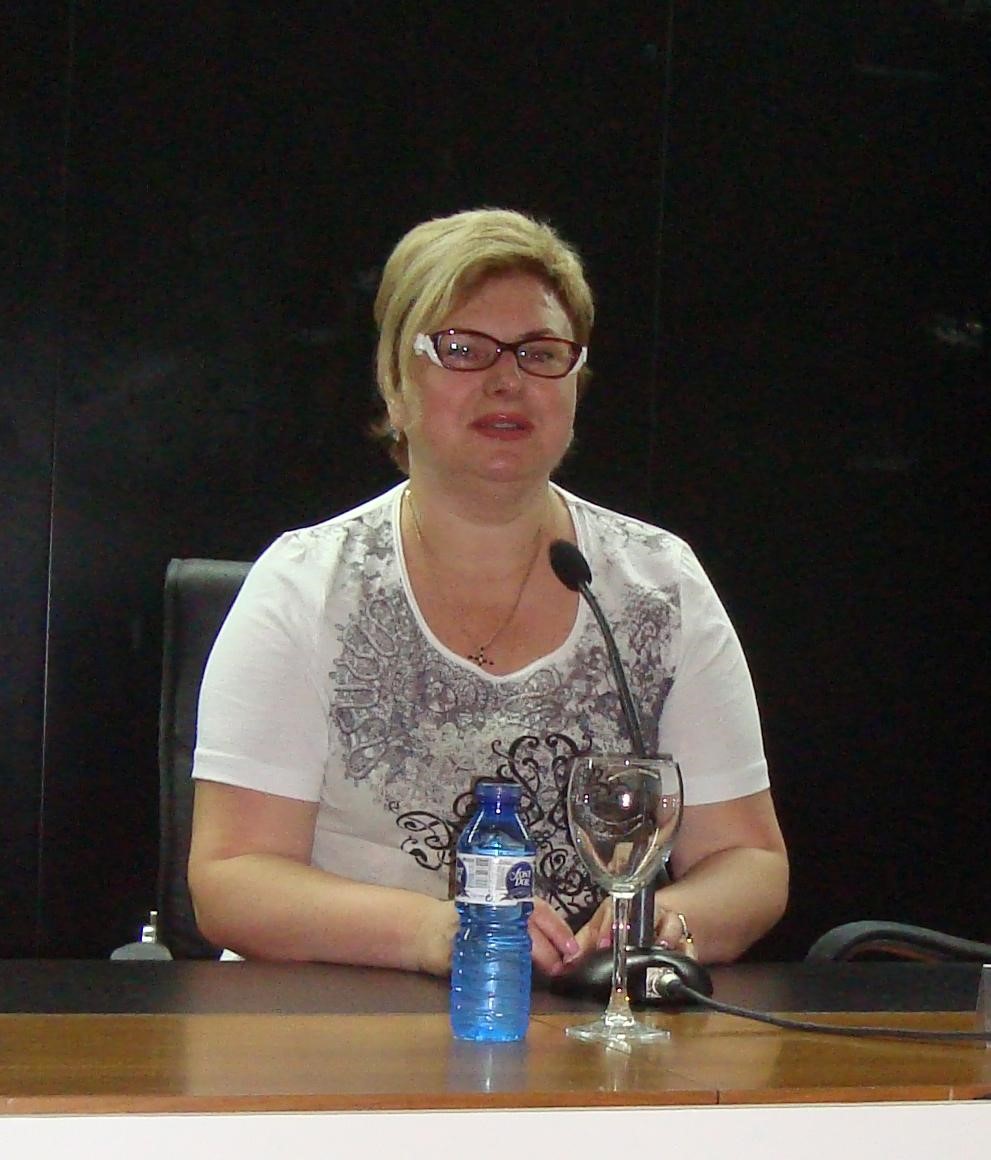 blonde woman at table with microphon