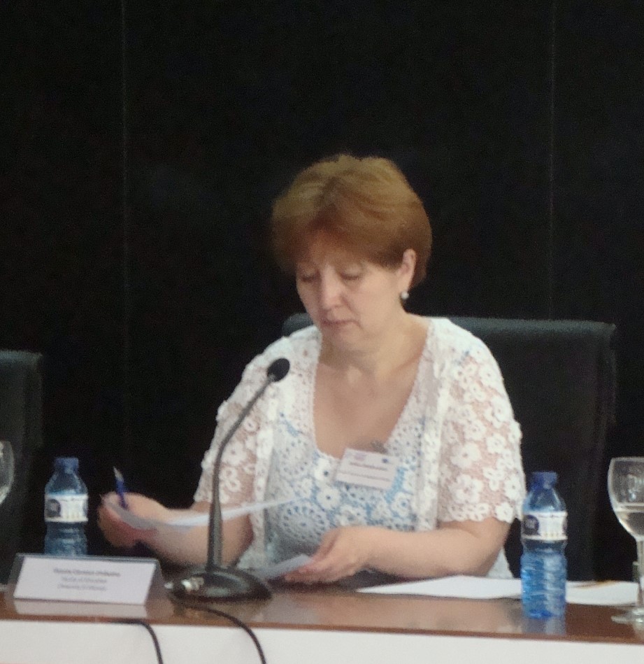 red haired woman at table with microphone